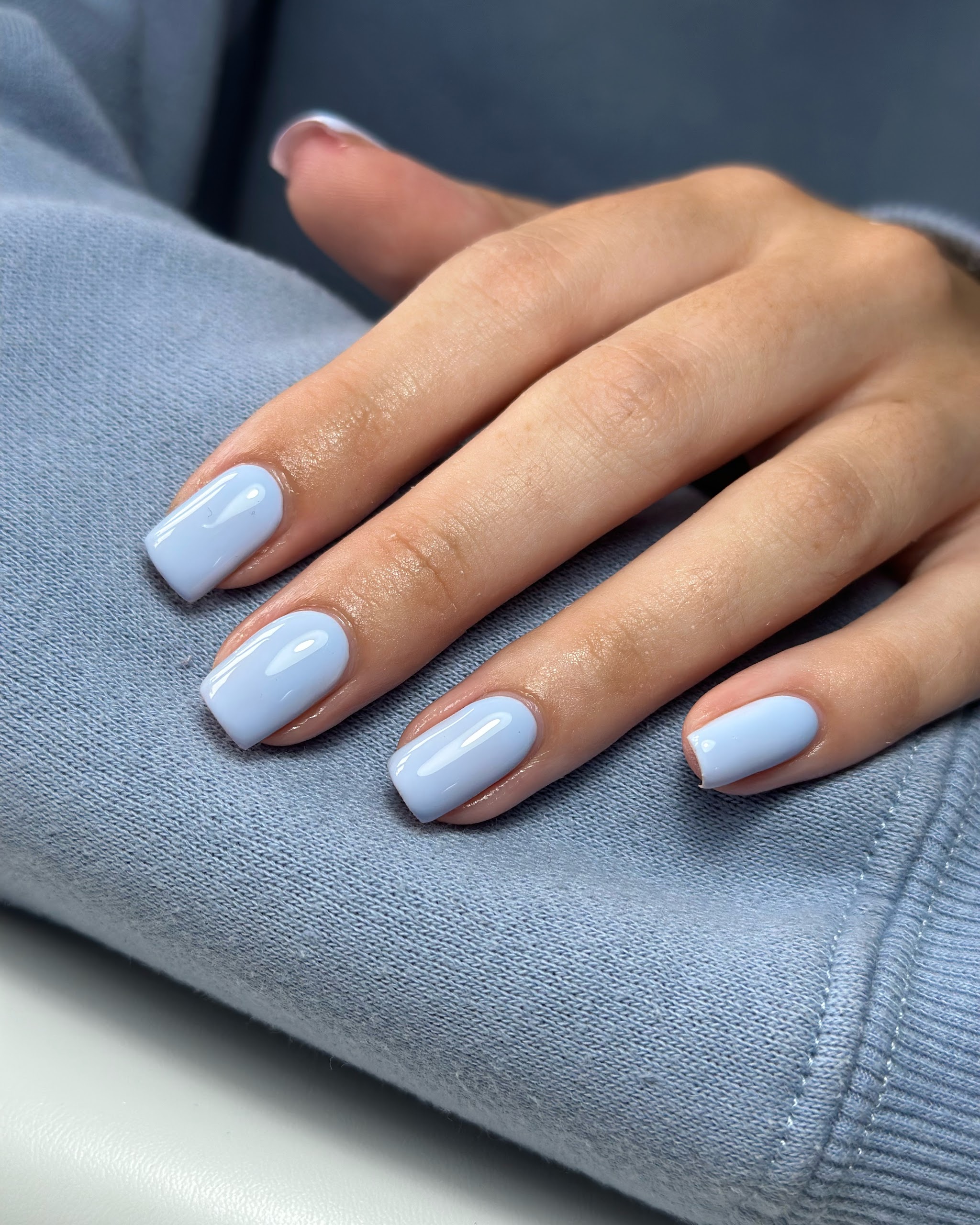 Short nails in a plain pale lilac-blue gloss