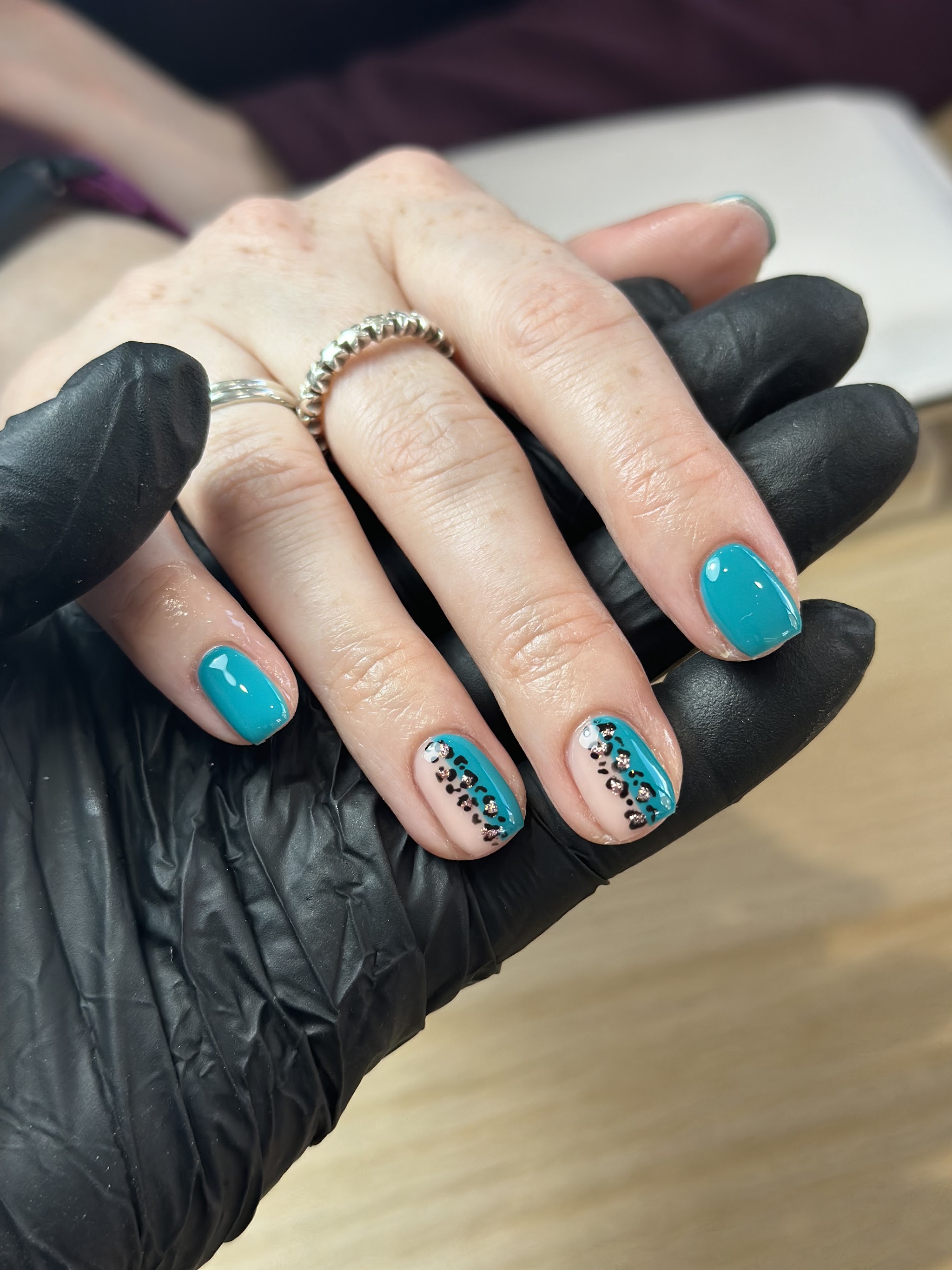 Teal gel nails with leopard print accent nails