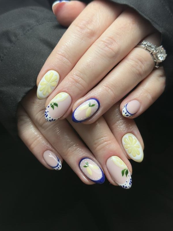 Nude nails with lemon slices and blue French tips